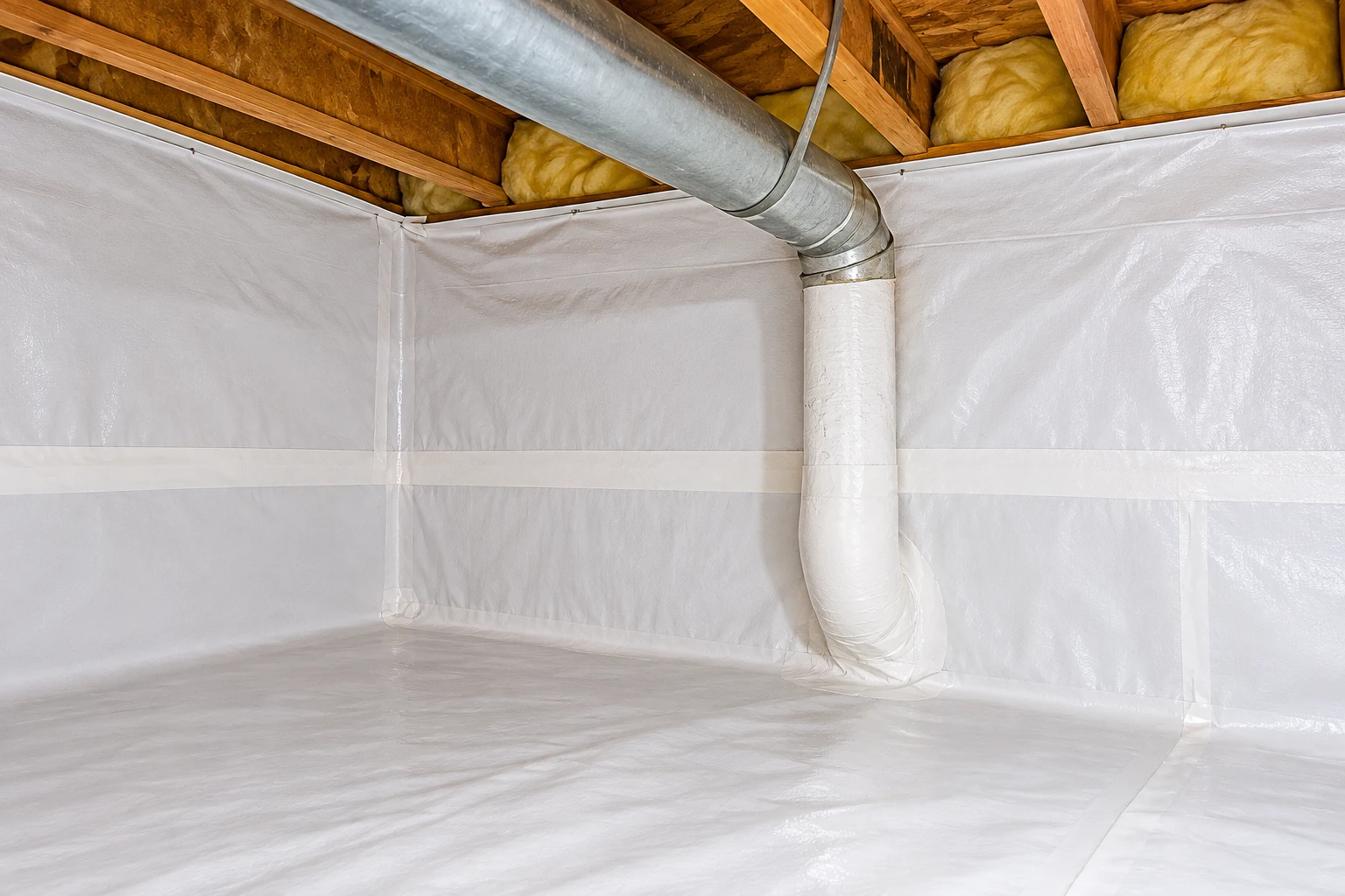 A crawl space is lined with white vapor barrier across the floor and walls, beneath exposed joists and yellow insulation.