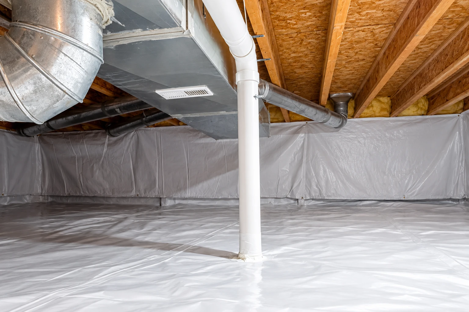 A crawl space has white plastic vapor barrier covering the floor and lower walls beneath exposed joists and ducts.